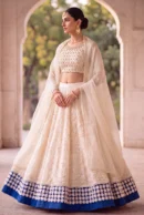Ivory Embellished Blouse with Ruffled Lehenga and Bold Blue Border